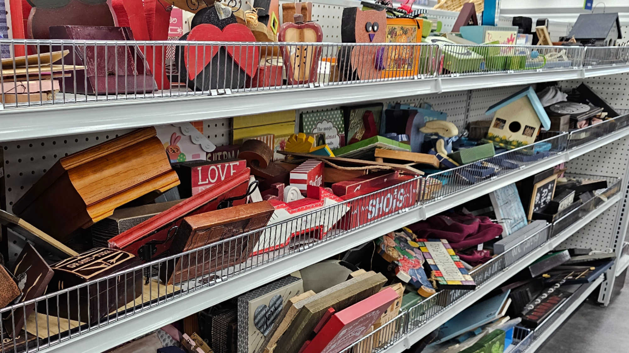 A row of shelves at DI featuring secondhand decor items that could be used to decorate a classroom.
